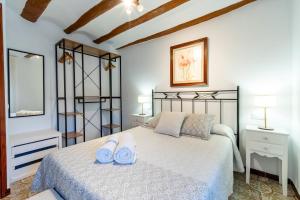 a bedroom with a bed with blue towels on it at CASA LA FELICIDAD in Beceite