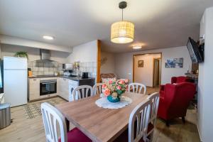 a kitchen and dining room with a wooden table and chairs at CASA LA FELICIDAD in Beceite