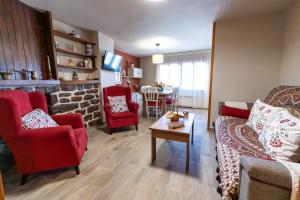 a living room with a couch and chairs and a table at CASA LA FELICIDAD in Beceite