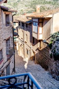 an alley in an old town with buildings at CASA LA FELICIDAD in Beceite