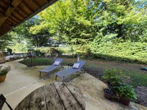 two chairs and a table on a patio at A La Maison in Les Repôts +3 photos