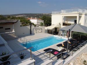 a villa with a swimming pool and a house at Villa Gina in Sevid