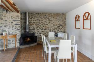 a dining room with a table and a fireplace at Pyrénées Mon Amour in Felluns +45 photos