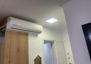 a ceiling fan in a room with a hallway at Redi Apartment Center in Elbasan