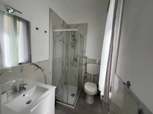 a bathroom with a shower and a toilet and a sink at Apartment, Sulina's House in Campofelice di Roccella