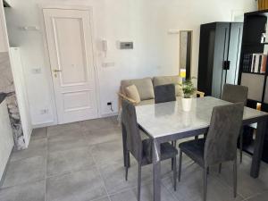 a dining room with a table and chairs and a couch at Apartment, Sulina's House in Campofelice di Roccella