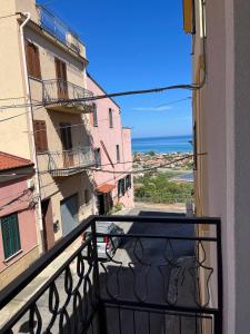a balcony of a building with a view of the ocean at Apartment, Sulina's House in Campofelice di Roccella