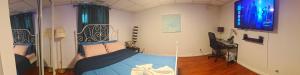 a bedroom with a bed in a room at Spacious Basement Lower Suite 3BR Home Stay 1 King 2 Queen Beds 2 Car Parkings FIFA 2026 in Pickering