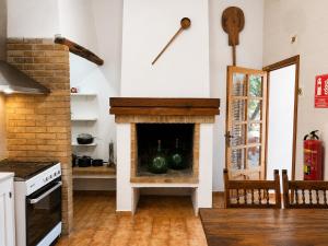 a kitchen with a fireplace with green watermelons in it at Can Pep Pardal in Sant Miquel de Balansat