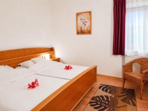 a bedroom with a bed with red bows on it at Ferienwohnungen Stecher in Bad Endorf