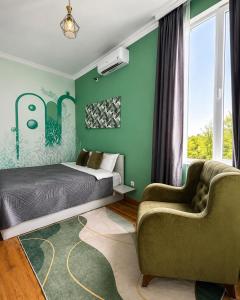 a bedroom with green walls and a bed and a couch at Green bunny ArtHouse in Martvili