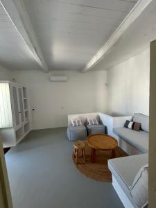 a living room with a couch and a table at Marpissa - Traditional House in Márpissa