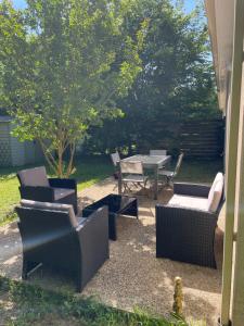 a patio with a table and chairs and a table and chairs at la maison de montpon in Montpon-Ménestérol