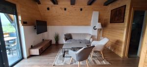 a living room with a table and chairs at Apartment & Cottage - Tune in Ripci