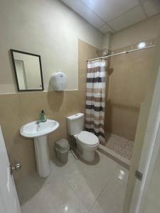 a bathroom with a toilet and a sink and a shower at Nómada San Miguel in Colonia Milagro de La Paz +14 photos