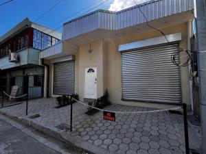 a house with a gate and a sign in front of it at Nómada San Miguel in Colonia Milagro de La Paz