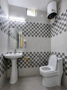 a bathroom with a toilet and a sink at Mahadevs Mansion in Rishīkesh +58 photos