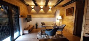 a living room with a couch and a table and chairs at Apartment & Cottage - Tune in Ripci
