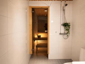 a bathroom with a toilet and a bench in it at Central location with sauna, private yard & parking in Rovaniemi +14 photos