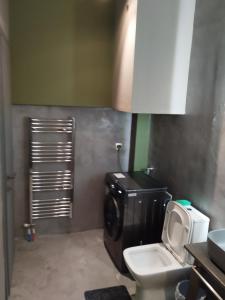 a bathroom with a toilet and a washing machine at Nova Ledeza NL II in Igoumenitsa +13 photos
