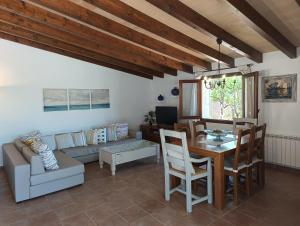 a living room with a table and a couch at La Sorteta De Cuxach in Pollença