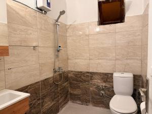a bathroom with a shower and a toilet and a sink at Eucalyptus Pension in Patara +25 photos