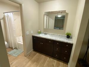 a bathroom with a sink and a mirror at Green River Inn Apartments in Green River +36 photos