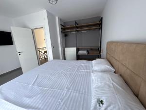 a bedroom with a large white bed in a room at Vila Mirko in Kotor +27 photos