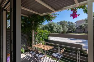 a patio with a table and chairs on a balcony at Elite City Apartments & Maisonettes in Lefkada