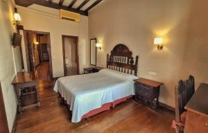 a bedroom with a large bed and a wooden table at Hotel Altamira in Santillana del Mar +32 photos