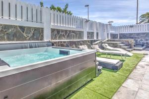 a hot tub in the backyard of a house at Seafront villa with jacuzzi in Maspalomas