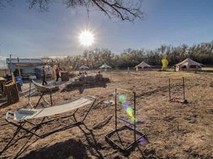 a group of chairs and a kite in a field at Bisti Badlands Tent in Farmington