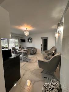 a living room with a couch and a table at Elite Apartaments in Curtea de Argeş +8 photos