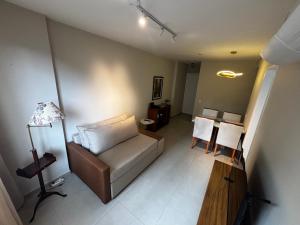 a living room with a couch and a table at Lar de Noel in Rio de Janeiro