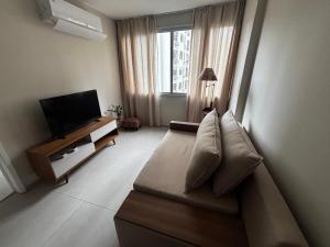 a living room with a couch and a flat screen tv at Lar de Noel in Rio de Janeiro