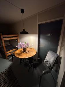 a small room with a table and a chair at Namiņš in Ragaciems +7 photos