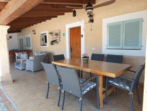 a wooden table and chairs on a patio at La Sorteta De Cuxach in Pollença
