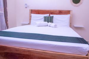 a bed with two pillows on top of it at Meyer Stays in Kilifi