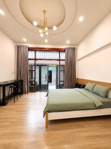 a bedroom with a bed and a piano at B786 Airport Apartment in Ho Chi Minh City