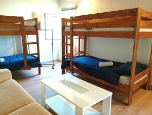 a living room with two bunk beds and a table at Surf House Gerra in San Vicente de la Barquera