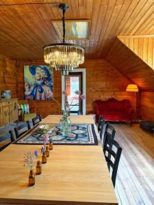 a dining room with a long table and a chandelier at Meiriet1936 in Fjarland