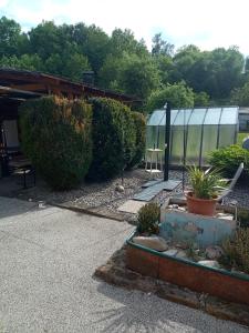 a garden with a tent and some plants and trees at Pohádka in Kunratice