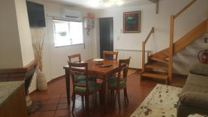 a dining room with a table and chairs and a staircase at Moradia Vinhais in Vinhais