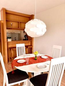 a dining room with a white table and chairs at Sorpesee Stay in Sundern