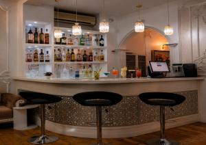 a bar with two stools in front of a counter at White House SPA Hotel in Baku