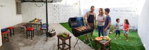 a group of people standing next to a grill at El delfín Santa Elena -Salinas in Santa Elena