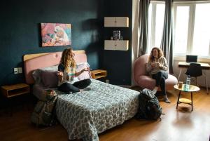 two girls sitting on a bed in a room at Wanderlust District in Mexico City
