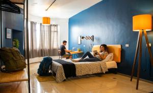 a woman sitting on a bed in a room at Wanderlust District in Mexico City +14 photos