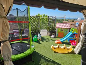 a childrens play area with a playground and slides at Residence Millennium in Rimini