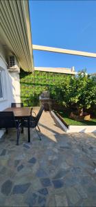 a picnic table and a bench on a patio at Pefkos Sea Shell in Pefki